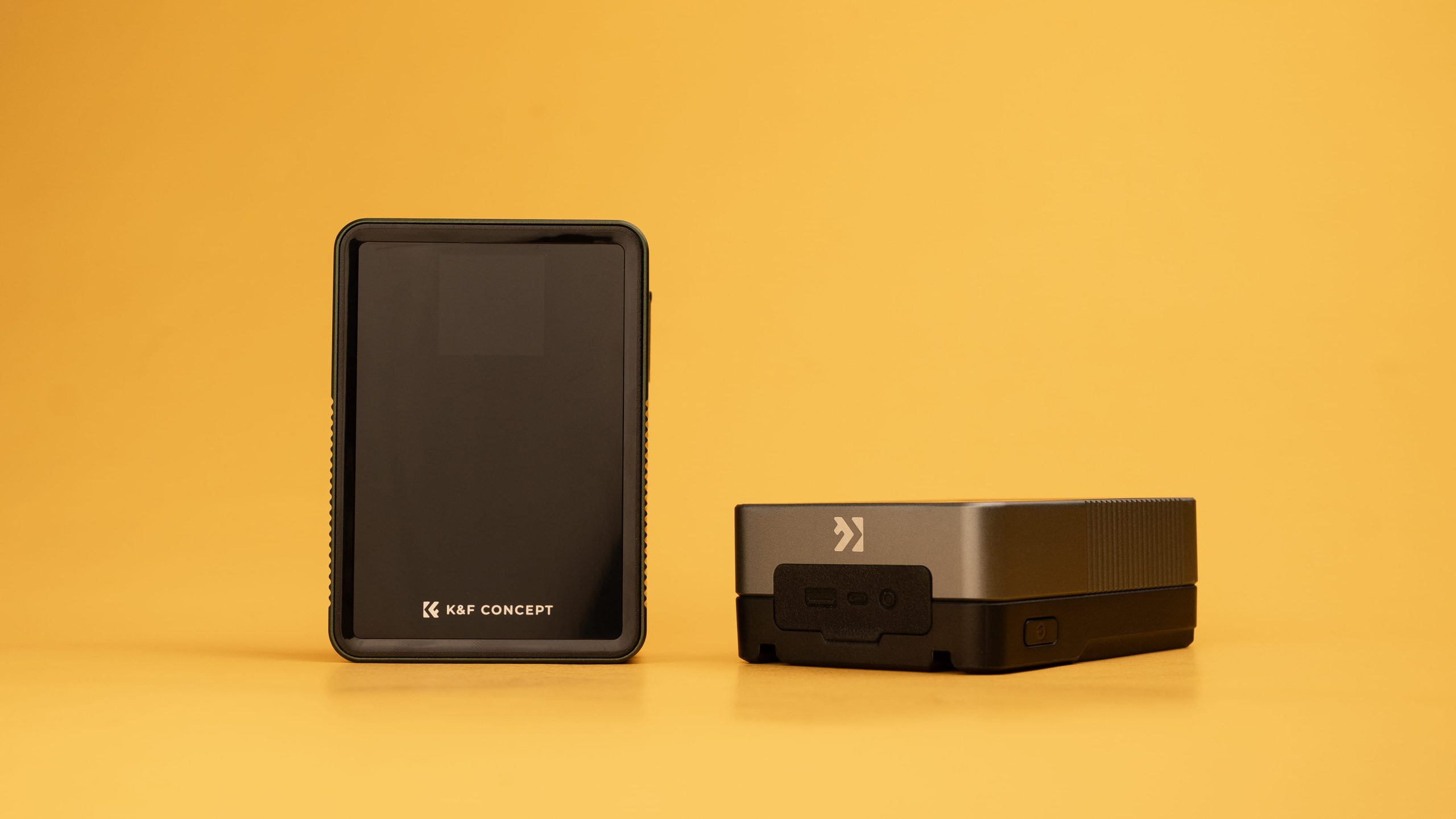 Two K&F Concept camera batteries on a solid yellow background